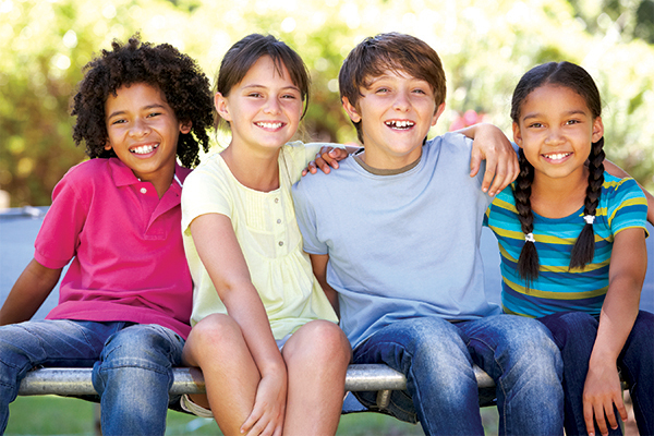 group of children sitting on bench