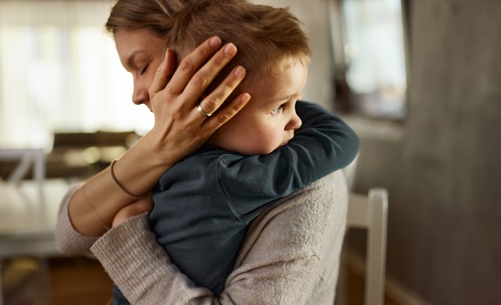 Mother hugging her young child