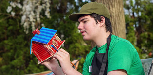 Teenager with autism outside doing a painting craft