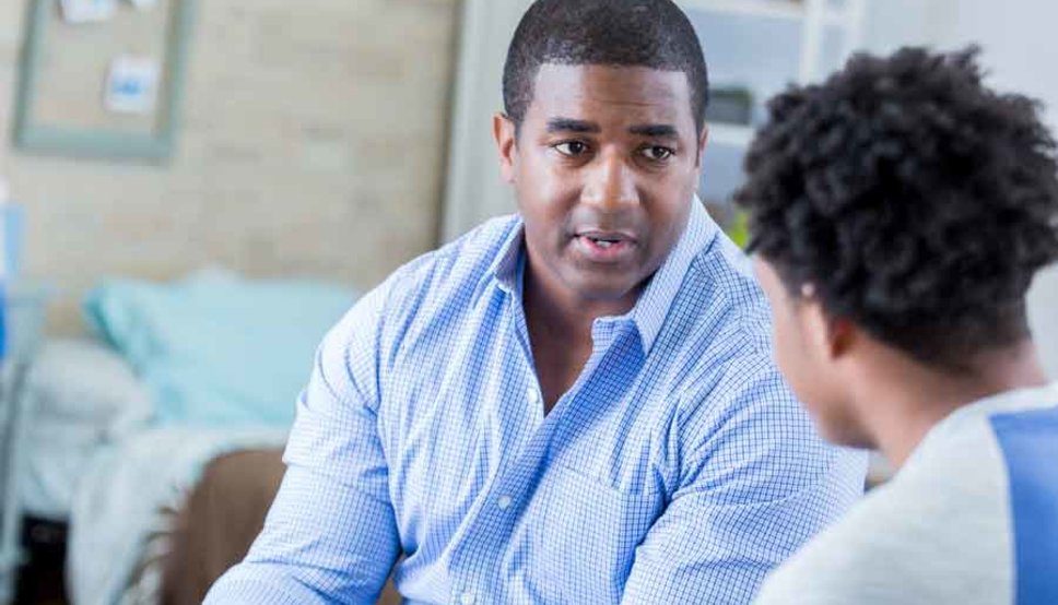 Serious Dad talking to son