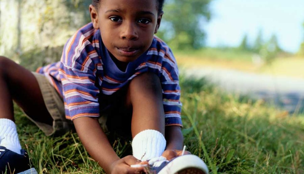 Boy tying shoes