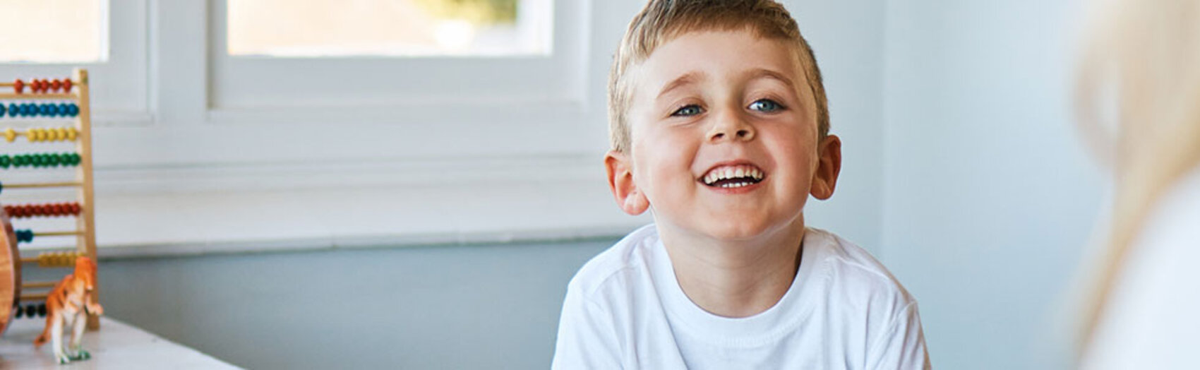 Boy playing and smiling with adult