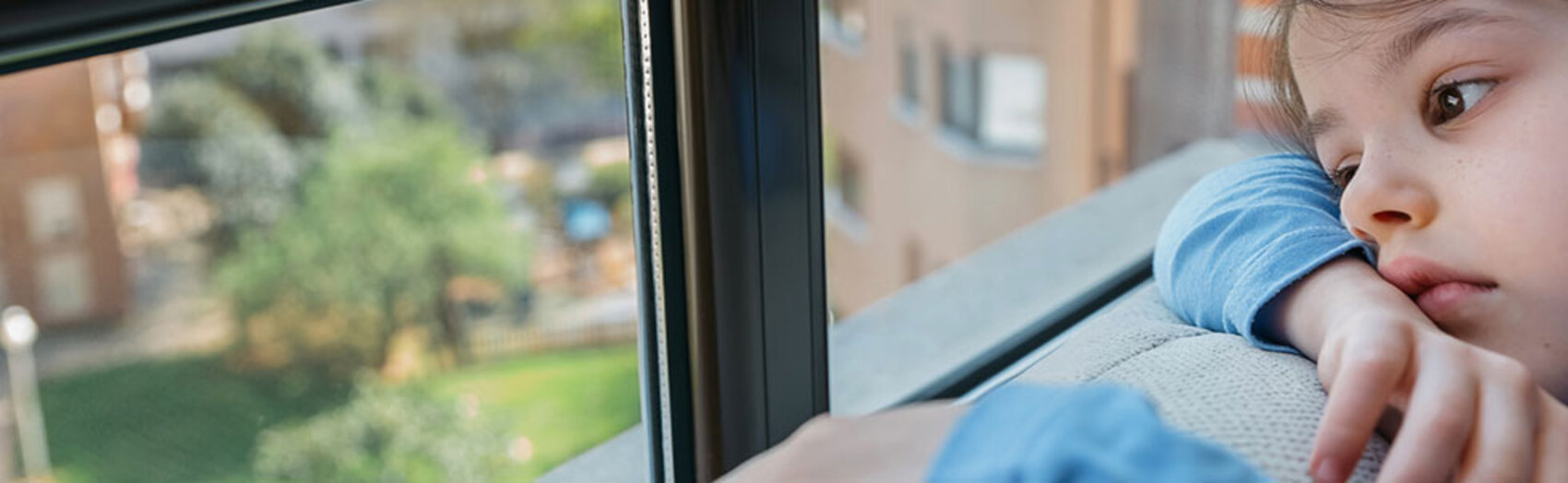 Sad girl looking out window