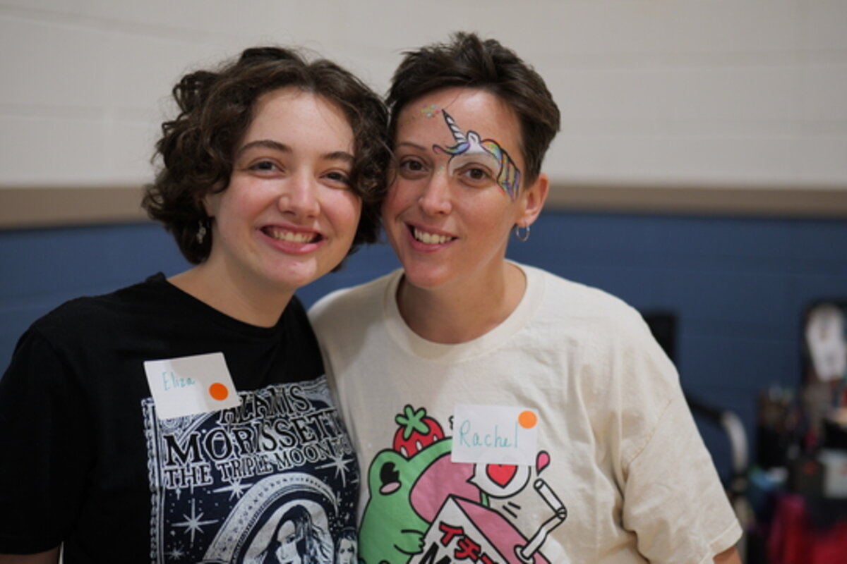 Two people smile at the camera.