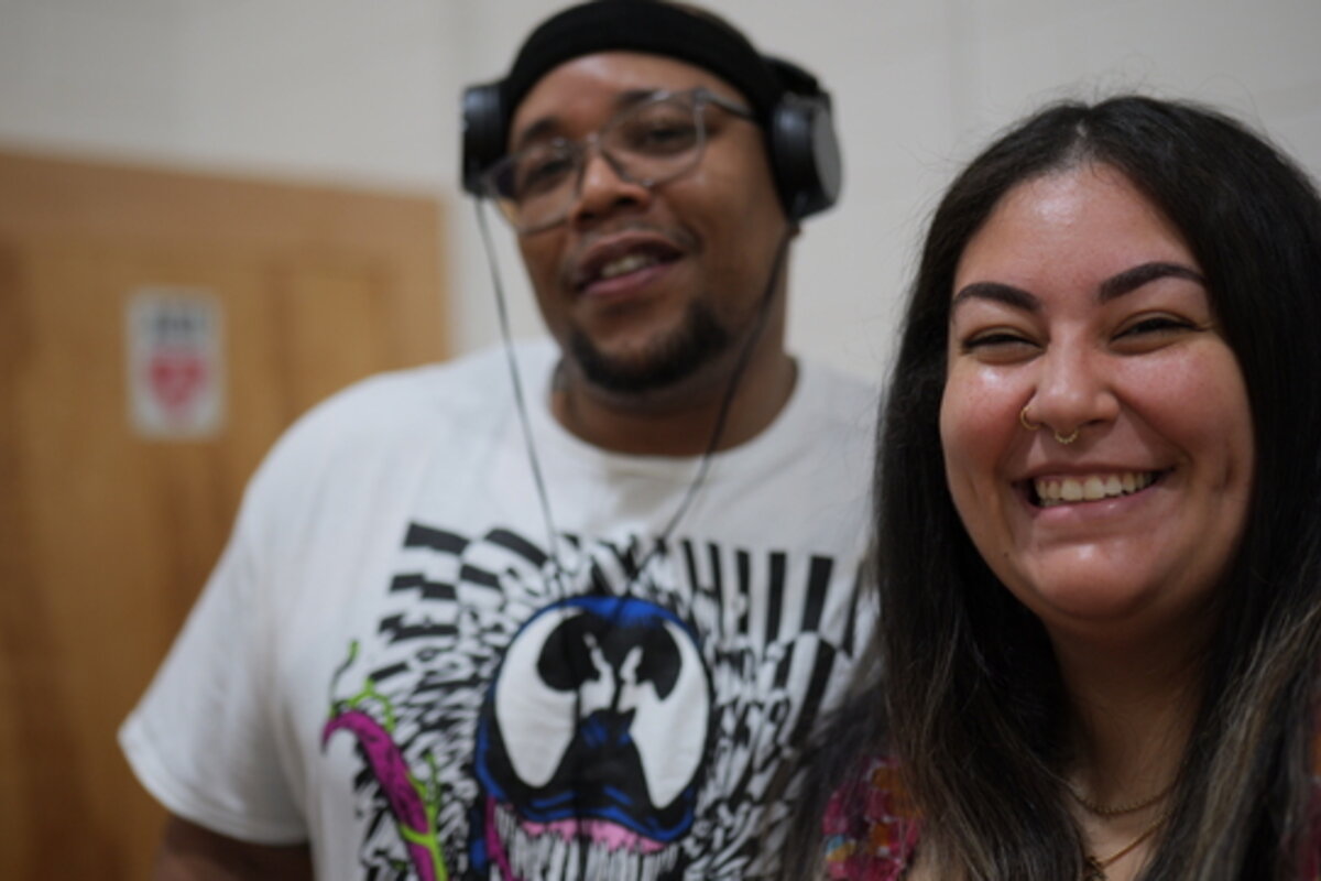 Two people smile at the camera.