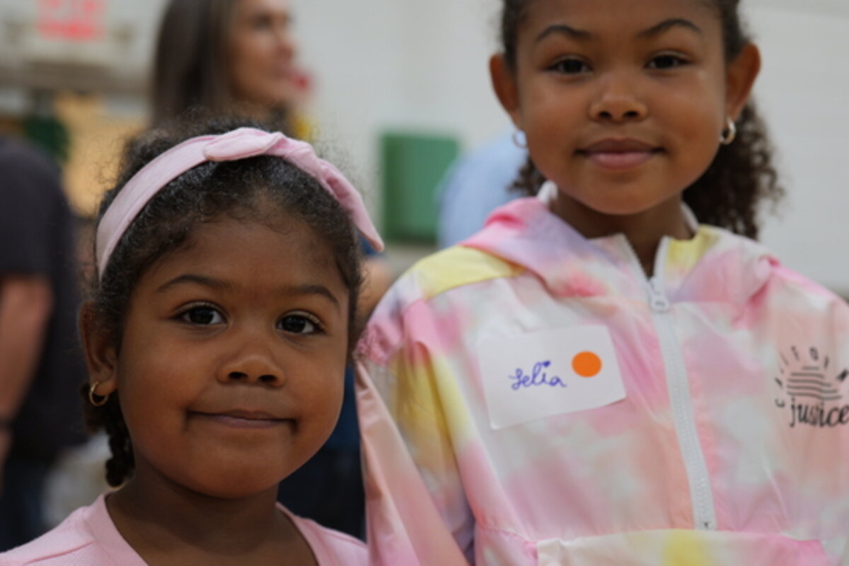 Two girls smile at the camera.