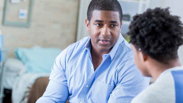 Serious Dad talking to son