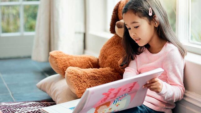 Young girl calming down with book